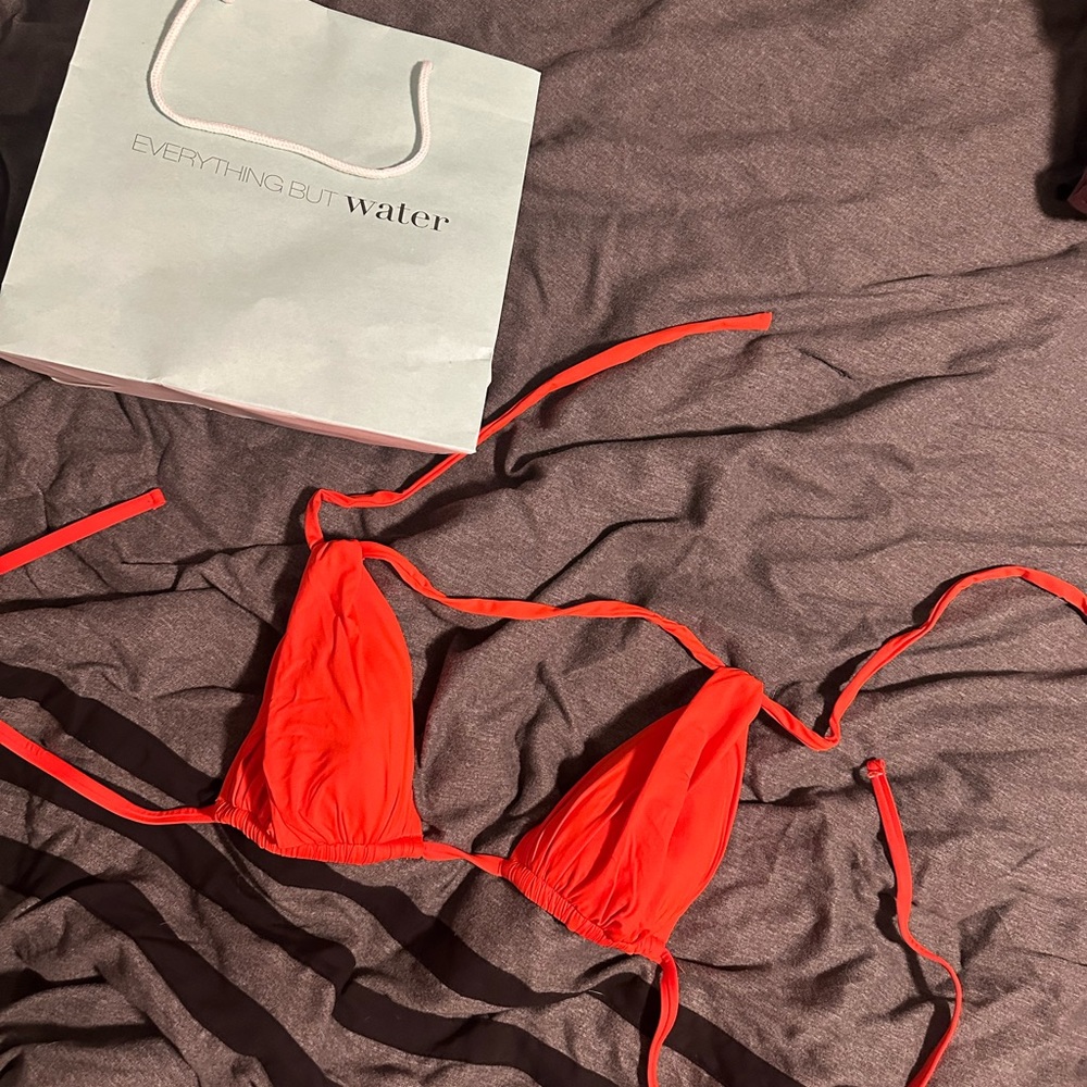 Bikini top never worn! Almost neon orange bikini top helps show off your tan!